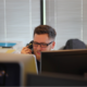 Customer service professional on the phone learning how to use contact center software